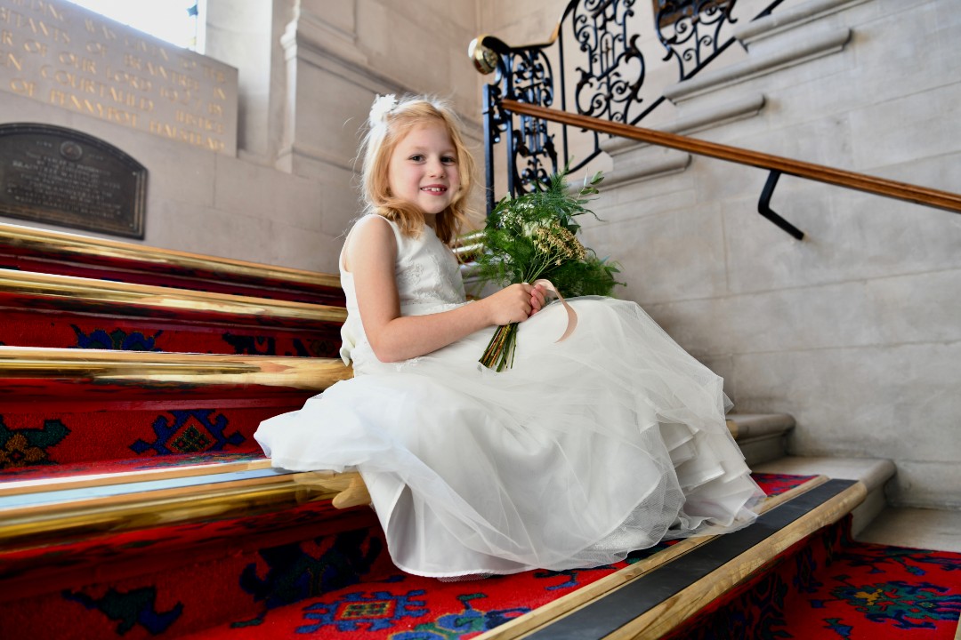 Child sitting on the main staircase at the town hall